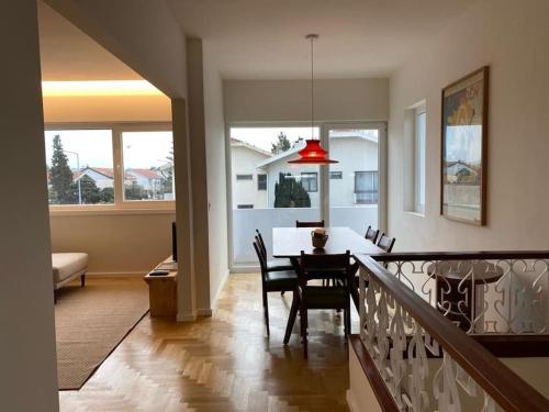 a dining room and living room with a table and chairs at Porto Aldoar Boutique Flat (Inês) in Porto