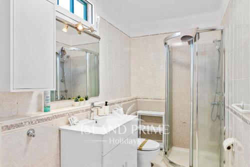 a bathroom with a shower and a toilet and a sink at Golf and Sea Views Holiday in Golf del Sur in San Miguel de Abona
