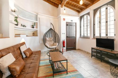 a living room with a couch and a swing at Casa Mourisca - Albino d'Óbidos in Óbidos