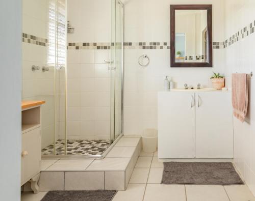 a bathroom with a shower and a sink at Klein Plekkie Self Catering Accommodation in Addo