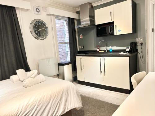a room with two beds and a kitchen at The Dome in London