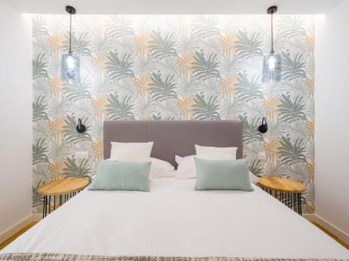 a bedroom with a large white bed with two pillows at Sea City by CanariasGetaway in Las Palmas de Gran Canaria