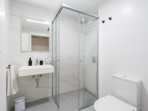 a bathroom with a glass shower and a sink at Sea City by CanariasGetaway in Las Palmas de Gran Canaria