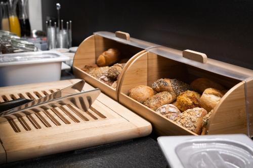 two wooden trays filled with different types of donuts at Zum Dallmayr Hotel Garni in Berching