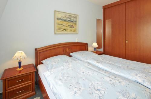 um quarto com uma cama com uma cabeceira de madeira em Villa Hintze em Heringsdorf