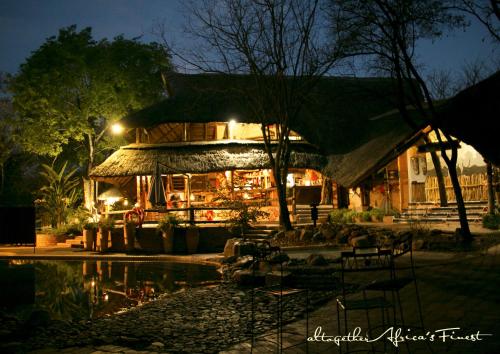 a building with a restaurant in the night at Victoria Falls Safari Suites in Victoria Falls