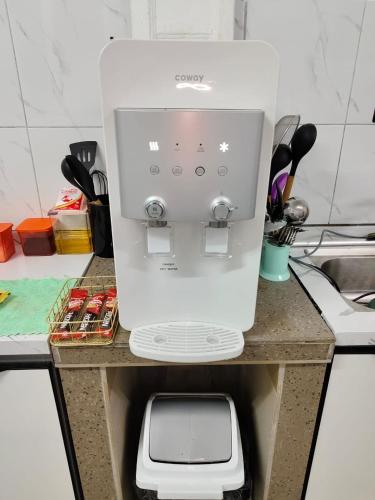 a white coffee maker on a counter in a kitchen at NASUHA HOMESTAY 1 TEMERLOH Semi-D House, 4 Bedroom, 3 Bathroom, 5 Unit Aircond, Free Wifi and Netflix, Near Hospital with Private Pool in Temerloh
