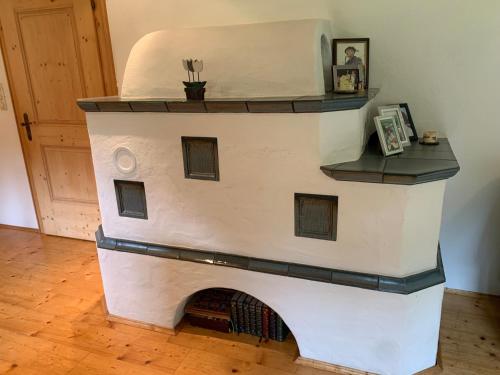 a white building with a fireplace in a room at Villa Carmen in Bichlbach