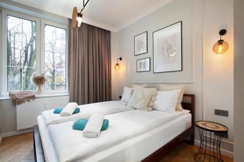 a large white bed in a room with a window at Elite Apartments Old Town Ogarna in Gdańsk