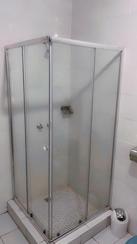 a shower stall in a bathroom with a toilet at Beautiful adventure in Chichili