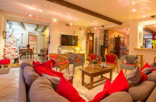 a living room with a couch and a christmas tree at Gite des Sources d'Arvey in Verrens-Arvey
