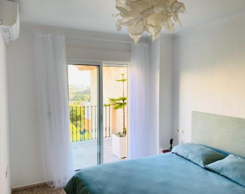 a bedroom with a bed and a large window at Open view Pinetree penthouse in Dehesa de Campoamor