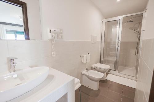 a bathroom with a sink and a toilet and a shower at Hotel Paistos Paestum in Paestum