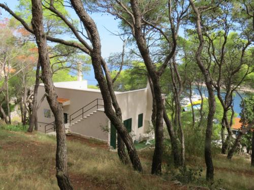 a house in a forest of trees at Holiday Lodge M3 in Žirje