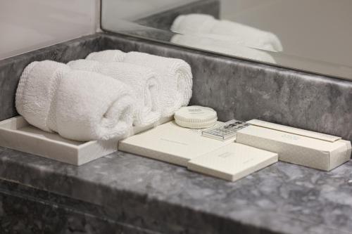 a counter top with towels and boxes on it at Visionary Vista: 2BR Al Habtoor City in Dubai