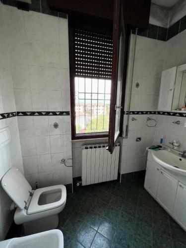 baño con aseo y lavabo y ventana en Intero Appartamento a Isola della Scala, en Isola della Scala