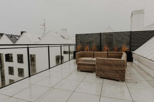 a balcony with wicker furniture on a roof at ApartView Porto Łeba by Rent like home in Łeba
