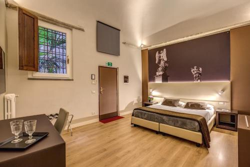 a bedroom with a bed and a table in a room at HiSuiteROME - ApartHotel in Rome