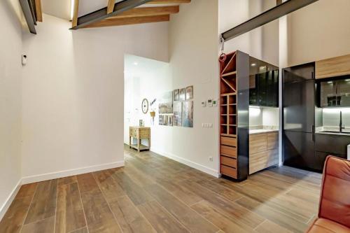 an empty living room with wooden floors and a large glass door at Apartamentos JAP Begoña in Gijón