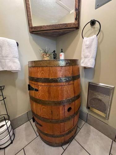 a bathroom with a barrel sink and a mirror at Bourbon Trail Cabin on the Farm in Lawrenceburg