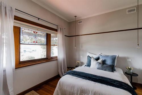 a bedroom with a large bed and a window at Dunrobin House in Shepparton