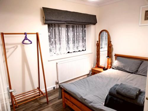 a bedroom with a bed and a mirror at Comfort Private Rooms in Three bedroom House in Bridgemary