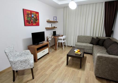 a living room with a couch and a table at Upart Home in Mersin