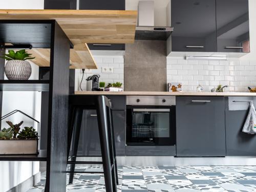 a kitchen with blue cabinets and a counter top at Maison rénovée au cœur de Thann : 3 chambres, cuisine équipée, proche randonnées et villes alsaciennes - FR-1-744-11 in Thann