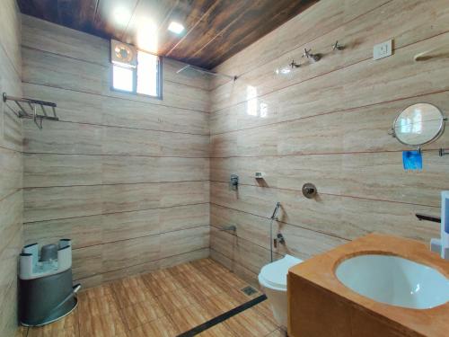 a bathroom with a toilet and a sink at Wet n wild water park & resort in Mendarda