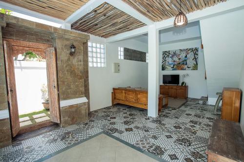 sala de estar con suelo de baldosa y TV en Karang Island Villa, en Nusa Lembongan