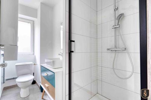a white bathroom with a shower and a toilet at La Casa Naia VI — Votre bulle d'air sur la côte in Douvres-la-Délivrande