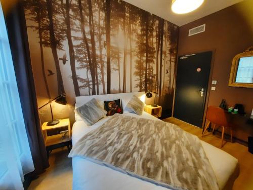 a bedroom with a bed with a teddy bear on it at Hotel Du Cygne Tours in Tours