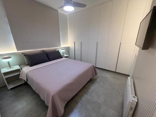 a bedroom with a large bed and white cabinets at Johnny's luxury getaway in Strovolos