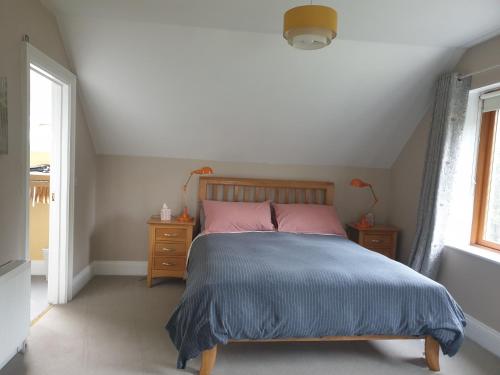 1 dormitorio con 1 cama con manta azul y ventana en FOREST VIEW Woodland lodge, en Ballard