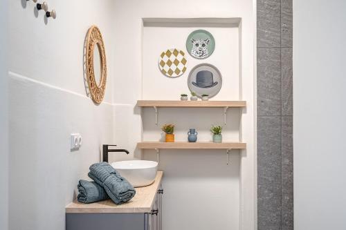 a bathroom with a sink and a mirror at Funky Penthouse City Center in Kaunas