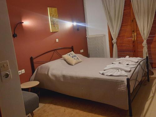 a bedroom with a bed in a room at Angelo Apartments Tolo in Tolo