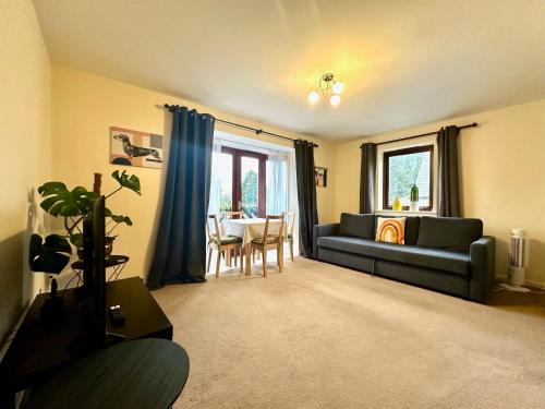 a living room with a couch and a table at Super Apartment next to Bicester Village Sleeps 4 in Bicester