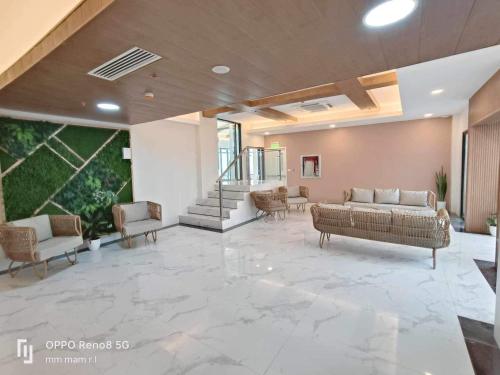 a lobby with couches and chairs in a building at 19F One Katipunan Residence in Manila