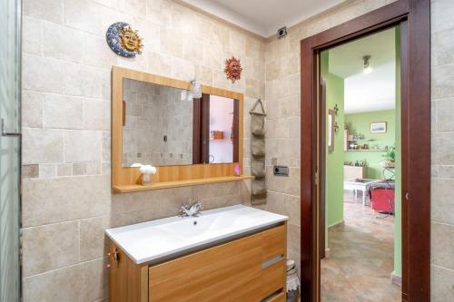 a bathroom with a sink and a mirror at Ático en primera línea de playa con vistas al mar in Cala del Moral