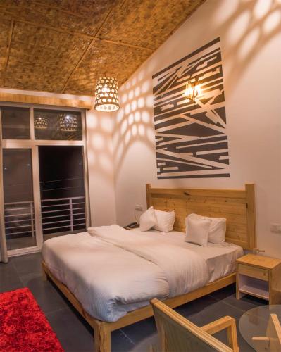 a bedroom with a bed and a window at juSTa Lazy Haven Corbett, Uttarakhand in Rāmnagar