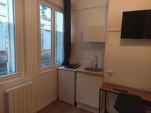 a small kitchen with a sink and a window at SAINT GERY 1 in Valenciennes