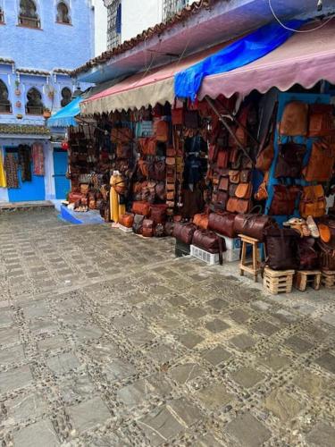 a market with a store with a bunch of bags at Dar Saphire in Chefchaouene