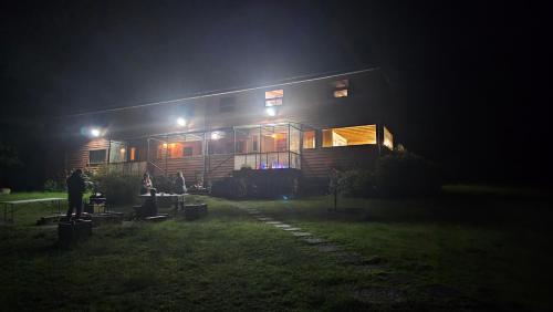 a house lit up at night in the dark at Hostal Hunter in Puerto Montt