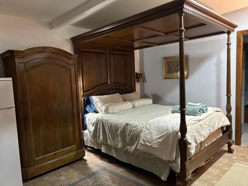 a bedroom with a canopy bed and a refrigerator at Jerusalem View in Mevasseret Zion