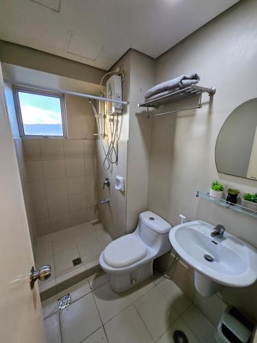 a bathroom with a toilet and a sink at 1BR Condo at Avida tower IT park cebu in Cebu City