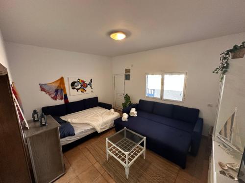 una sala de estar con un sofá y una cama en SONRYE Graciosa, en Caleta de Sebo