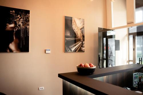 a kitchen with a bowl of fruit on a counter at Olivia Rooms in Belgrade