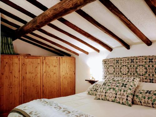 1 dormitorio con 1 cama con techo de madera en Casa rurale Colleccio - colline di Lucca, en Fibbialla