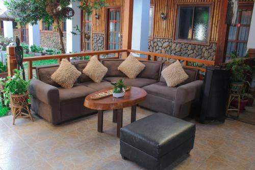 a living room with a couch and a table at Bea's Garden Inn in Puerto Princesa City