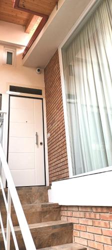 a house with a white door and a window at Rosa's House in Vazzano